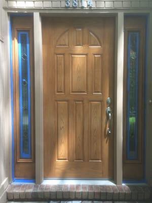 Fiberglass door rehung and first coat of stain applied.