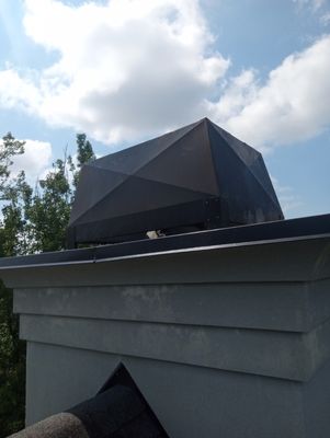 New Black chimney cover installed to fix leaks.