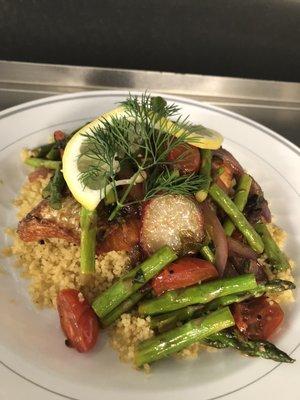 Wild salmon fillet over herbed cous cous with warm asparagus salad.