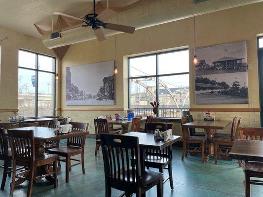 Large Beautiful dining room with historic photos and lots of windows with a view of the bridge