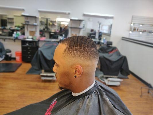 Waves on top with a bald fade on the sides