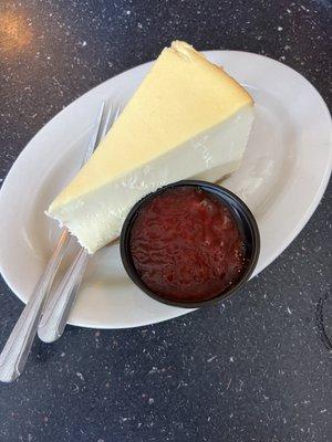 Cheesecake with strawberry sauce on the side