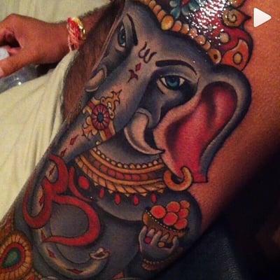 Close up full color Ganesh tattoo on dark skin. (Fresh)