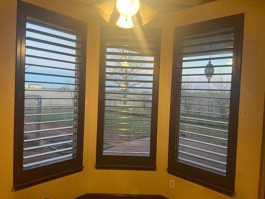 Stained shutters matching the existing frames in a kitchen.