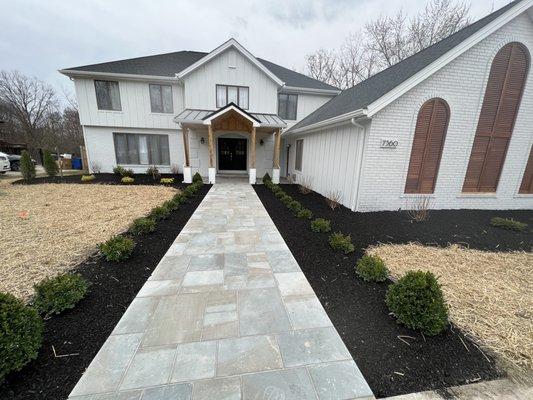 Boxwoods line the bluestone walkway he installed. At night we have uplighting he installed that shines on the three trees he installed home.