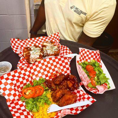 Loaded potato , yellow rice and flavored chicken chunks with salad