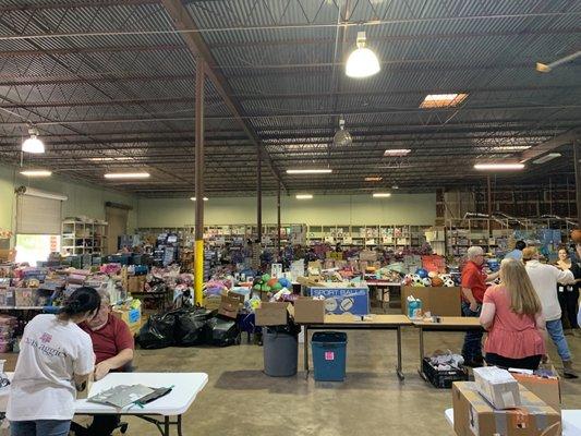 Inside the warehouse during Christmas- volunteers are needed to pick, wrap, and sort gifts for 16,000+ children