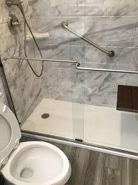 Low threshold shower base and grab bars.