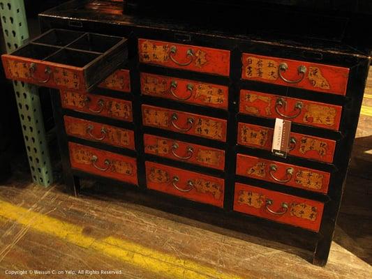 A Chinese cabinet of apothecary drawers.