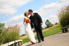 wedding couple kissing on bright sunny day