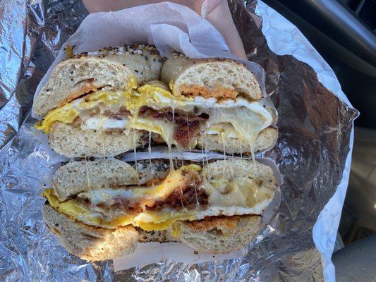 Two eggs over medium, well-done bacon, pepper jack and hot sauce on a toasted everything