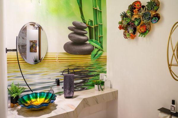 Powder room half bath Zen inspired design with hand blown glass basin.