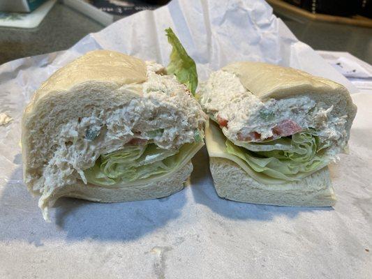 Chicken salad with Swiss, lettuce and tomato.