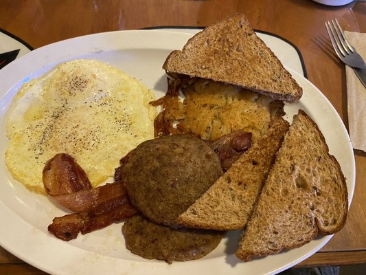 2 Eggs, Toast and Hash Browns, with bacon and sausage added.