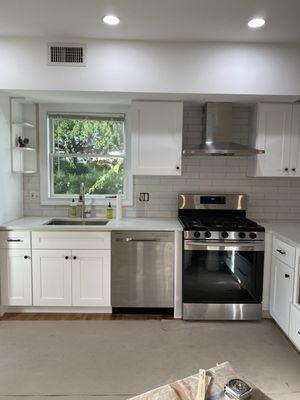 Great job installing the range hood, and good view of the cabinets.