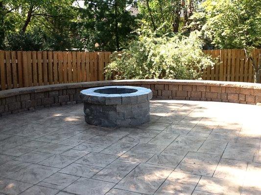 Firepit with stamped concrete patio and retaining wall