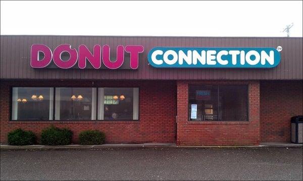 This Donut Connection is located in a strip mall with ample parking out front.