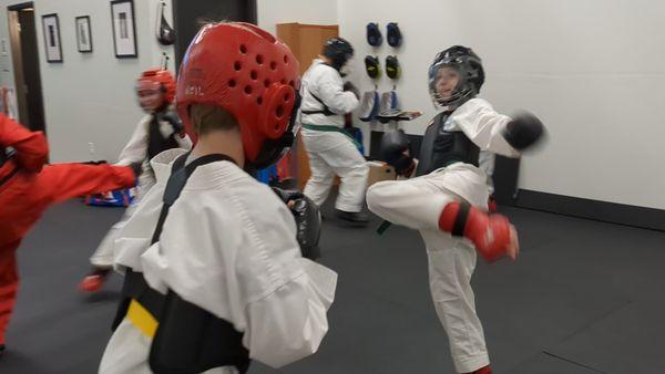 Traditional sparring in Tae Kwon Do develops focus, improves reaction times, and provides the best cardio workout ever!