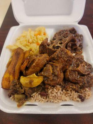 Curried Goat Oxtail Rice and Beans Steamed Cabbage Fried Plantains