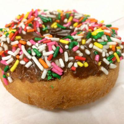 Chocolate-frosted donut with speckles, so nice.