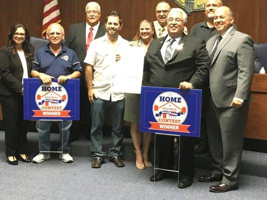 Mayor and Council present business beautification award to Mr. Alba