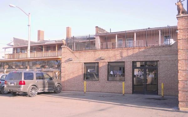 entrance from parking lot, showing seasonal patio area off to the side