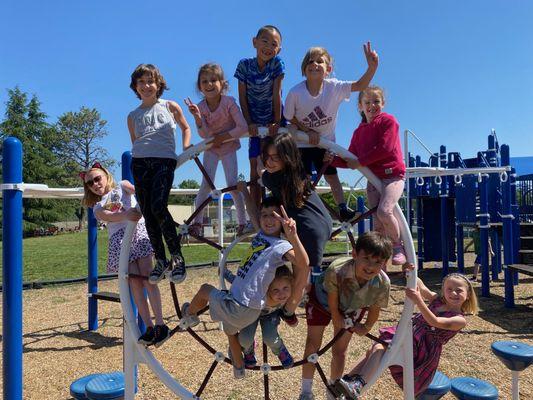 Students of all ages play and socialize together on the playground.