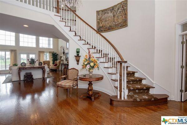 beautiful living room and curved staircase