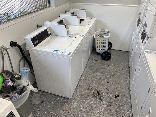 "Newly remodeled" laundry room with only two washers working and puddles of water on the floor