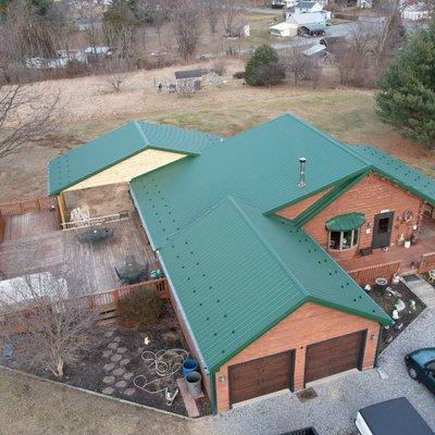 Green metal roof install supplied by Ridgetop Roofing