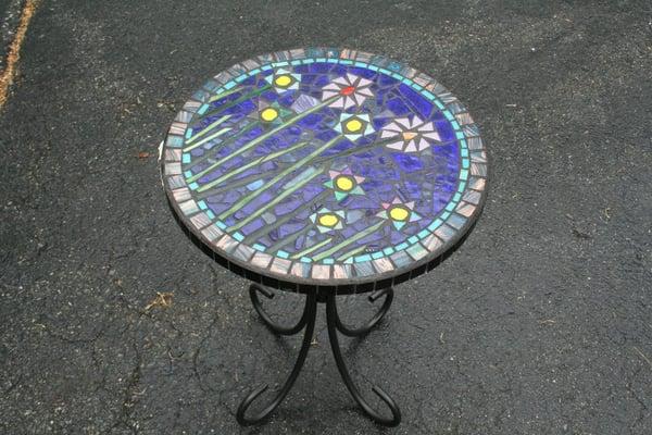 A table made at a mosaic patio table workshop