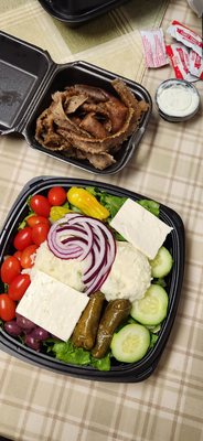 Big chunks of feta and potato salad on top of the Greek salad