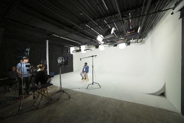 Pre-lit white cyc wall and sound studio, perfect for shoots and video production.