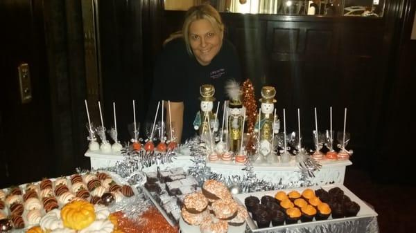 The owner setting up a holiday dessert table!!!!