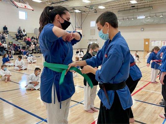 Mr Tjeerdsma ties on Ms Catherine's new Green Belt