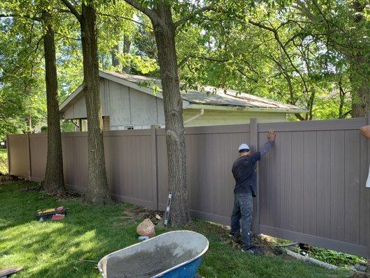 Installing new composite style fencing on the back line of a property.