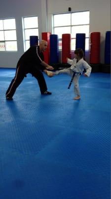 Shannon, one of Mr. Michael's students breaking a board during her belt advancement test.