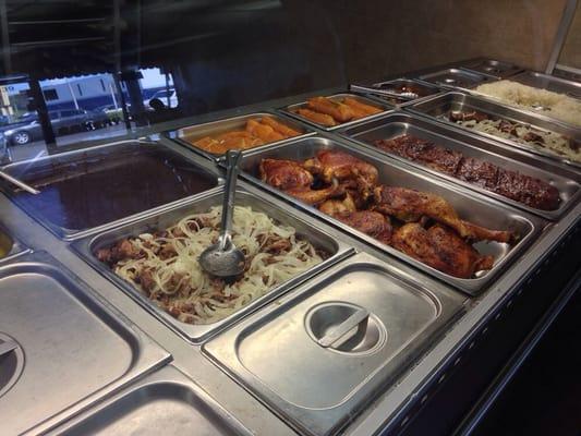 Warming table of prepared Cuban food.