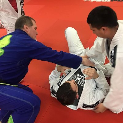 SBG BJJ Black Belt Paul Sharp, the highest graded BJJ player in the Elgin Illinois area, provides personal instruction to two beginners.