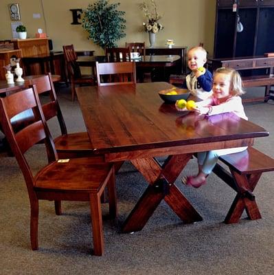 The Kelly Table features a distressed extra-thick top, an X shaped base and looks great paired with a matching bench on one side.