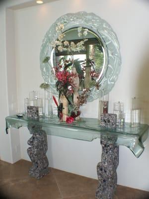 Credenza with hanging glass framed mirror and slumped glass