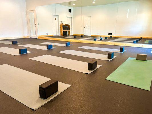 Our studio has offers a mirrored wall, windows and natural light and recycled rubber flooring that is truly ideal for hot yoga.