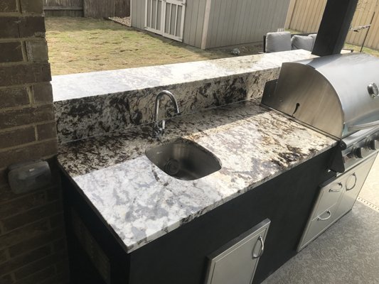 This is one of my projects from scratch. An outdoor barbecue pit. We build the brick frame and level to set the countertops with the sink.