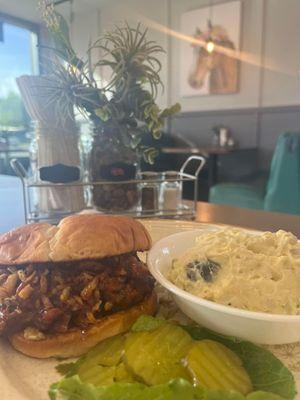 Pulled pork sandwich with homemade potato salad.