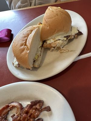 Bacon, egg and cheese on a hard roll with a side of bacon.