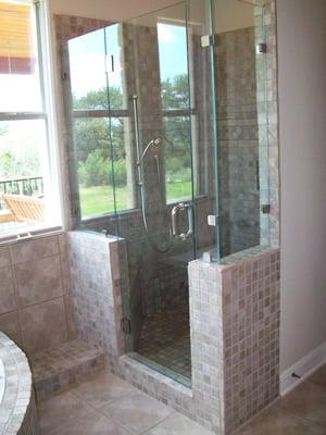 custom built walk in shower with seamless glass and multi shower heads