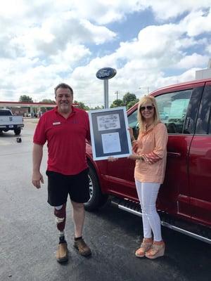 Cecil Peevey, one of our Sales Consultants being presented with an Excellence Award by our General Manager, Farah Simmons.