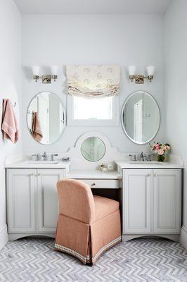 His and hers vanities, to include a makeup mirror inlaid back splash