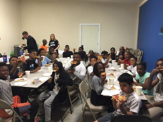 Enjoying pizza with our Urban Promise Kids!