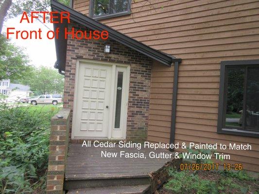 Cedar siding replaced on front. Fascia wrapped in dark bronze aluminum mastic, window trim wrapped in same aluminum.